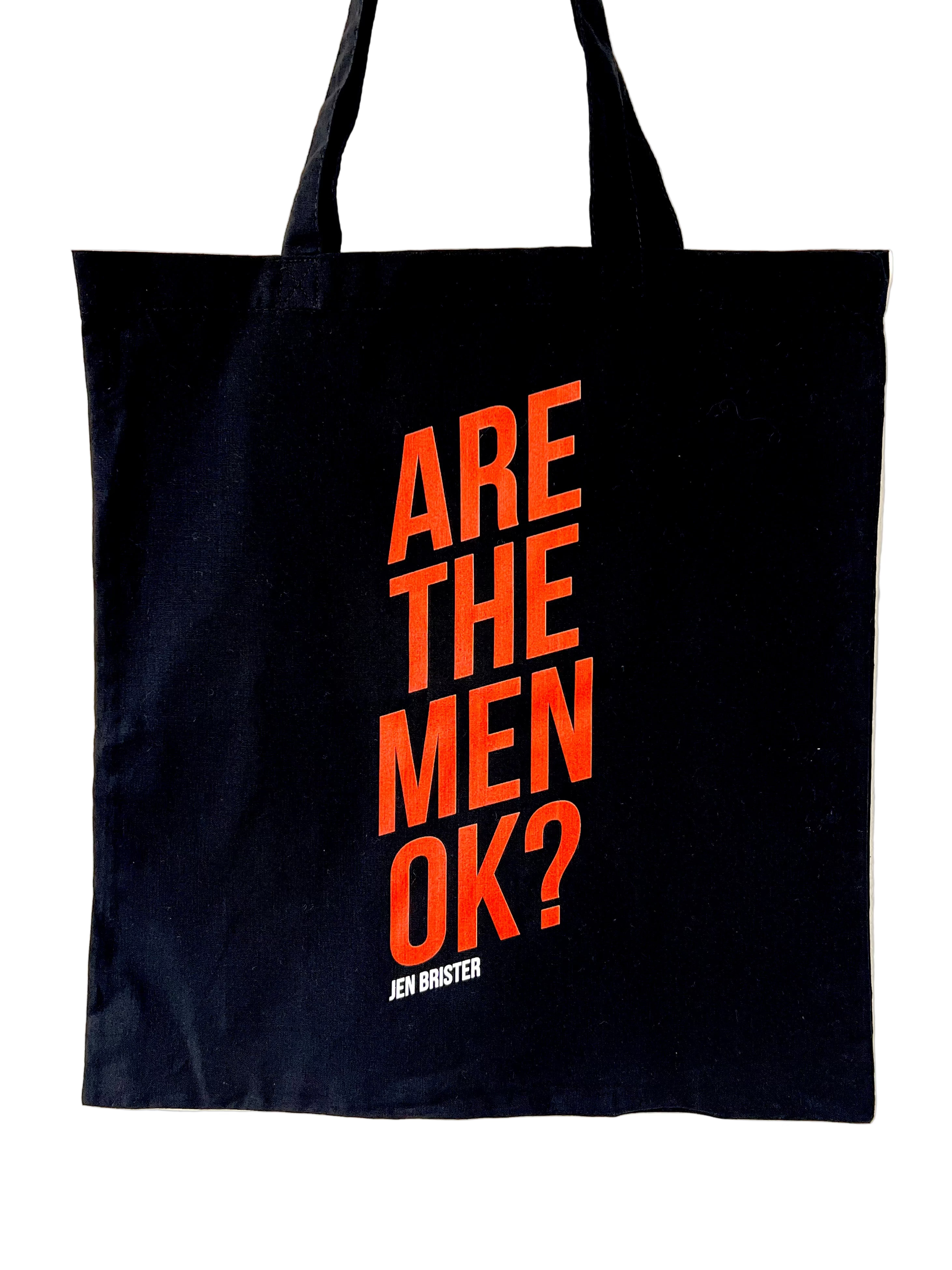 Black tote bag with orange text 'ARE THE MEN OK?'