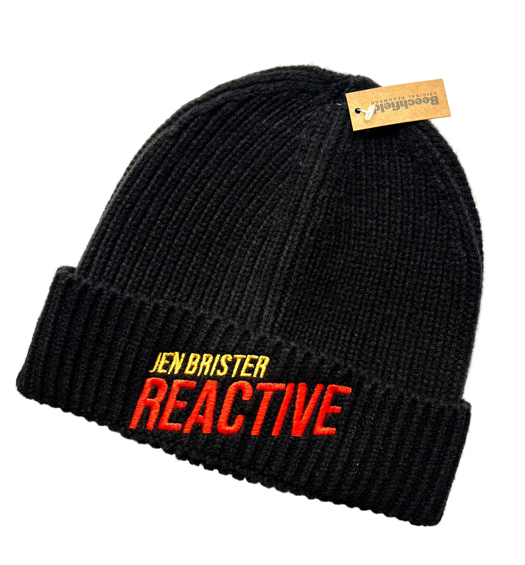 Black beanie with 'Jen Brister Reactive' text in orange and yellow