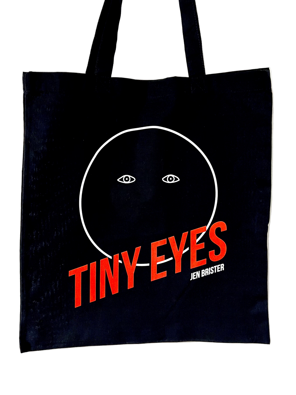 Black tote bag with 'Tiny Eyes' design and orange text